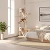 A cat tree is placed in a bedroom next to a bed and a window. Náhled obrázku produktu