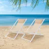 Two beach chairs on a sandy beach with the ocean and palm fronds in the background. Produktbild-Vorschau