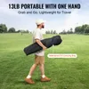 A man walking in a grassy field carrying a black carrying bag. Produktbild-Vorschau
