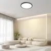 A modern living room with a sectional sofa, coffee table, and a ceiling light. Voir les images du produit