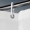 A close-up view of a white shower curtain hook attached to a shower curtain rod and a shower curtain. Podgląd zdjęcia produktu