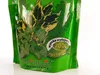 A close-up of a green product package with images of plants and text indicating its features. Produktbild-Vorschau
