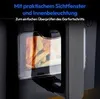 Close-up of the interior of a black air fryer with food being cooked, showing a transparent window and internal lighting. Produktbild-Vorschau