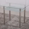 A glass table with metal legs on a rug. Náhľad obrázku produktu