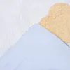 A close-up view of a bedding set with a blue and tan pattern. Produktbild-Vorschau