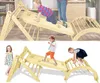 A collage of two images showing children playing on a wooden climbing structure indoors. Produktbild-Vorschau