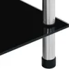 A close-up view of a shelf unit with a black glass shelf and silver metal legs. Náhled obrázku produktu