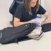 A young person is studying at a desk with a backpack and books. Produktbild-Vorschau