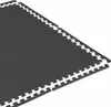 A close-up, angled view of interlocking dark gray puzzle mats on a white background. Voir les images du produit