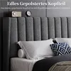 A close-up view of a grey upholstered headboard with pillows on a bed. Produktbild-Vorschau