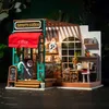 A miniature diorama of a coffee shop with a Halloween theme, featuring a grim reaper figure and ghost decorations. Anteprima dell’immagine prodotto