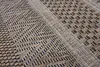 A close-up view of a woven rug with a geometric pattern. Náhľad obrázku produktu