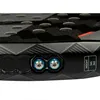 A close-up view of the bottom of a black and gray patterned object, possibly a piece of sports equipment, showing two blue screw mechanisms and text indicating weight options. Produktbild-Vorschau