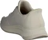 A side view of a white Skechers sneaker against a white background. Voir les images du produit