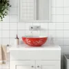 A bathroom vanity with a red and white ceramic vessel sink. Produktbild-Vorschau