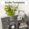 A close-up view of a gray TV stand with decorative items on top, including a vase of flowers and picture frames. Dimensions are indicated with text overlays. Náhled obrázku produktu