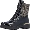 A black lace-up boot with a patterned cuff and gold trim. Voir les images du produit