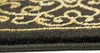 A close-up view of a carpet with a black background and gold ornamental pattern. Produktbild-Vorschau