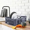 A kitchen counter with a dish rack filled with plates, cutlery, and a mug. Produktbild-Vorschau