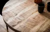 A close-up shot of a round wooden table with two black cups and a decorative item on it. Anteprima dell’immagine prodotto
