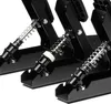 Close-up view of three black pedals with springs and metal components. Produktbild-Vorschau