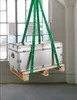 A silver trunk is being lifted by green straps, resting on a wooden pallet, in front of a large window. Produktbild-Vorschau