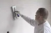 A person is plastering a wall with a trowel. Anteprima dell’immagine prodotto