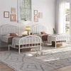 A bedroom scene with two white metal twin beds. Produktbild-Vorschau