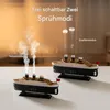Two vintage steamship-shaped diffusers emitting mist, set against a soft, warm background. Produktbild-Vorschau