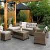 An outdoor lounge set is arranged on a patio under a wooden pergola, with a garden and a small wooden structure in the background. Náhľad obrázku produktu