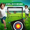 Two children are running on a soccer field with a soccer goal and target in the background. Produktbild-Vorschau