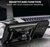 A black phone case with a ring stand is displayed on a table next to a laptop and headphones. Produktbild-Vorschau