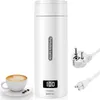 A white portable electric kettle with a digital display and a power cord with a European plug, next to a cup of coffee. Produktbild-Vorschau