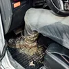 A person's muddy boot is on the floor mat of a car. Produktbild-Vorschau