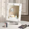 A white makeup mirror with LED lights is displayed on a white table, surrounded by makeup brushes and lipstick. Produktbild-Vorschau