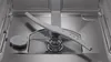 The interior of a clean, empty dishwasher, showing the spray arm and filter. Voir les images du produit