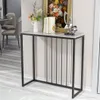 A console table with decorative items on top, placed in a room with dining chairs and a table in the background. Podgląd zdjęcia produktu