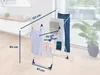 A drying rack with clothes on it, with dimensions indicated by lines and text. Produktbild-Vorschau