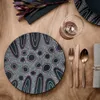 A table setting with a plate, cutlery, and a wine glass on a wooden table. Náhled obrázku produktu