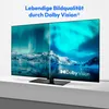 A television screen displaying a split image of the aurora borealis over a snowy landscape, with the Dolby Vision logo visible. The TV is placed on a shelf. Produktbild-Vorschau