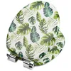 A toilet seat with a tropical leaf pattern on a white background. Produktbild-Vorschau