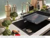 A kitchen sink with a baking tray over it, broccoli, and decorative items. Podgląd zdjęcia produktu