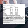 A person's legs are visible in the background, and the foreground shows a nutritional information label for a weight gainer product. Produktbild-Vorschau