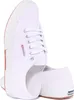 A pair of white Superga sneakers shown from a side angle. Voir les images du produit