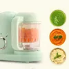 A baby food maker with chopped carrots inside the blender jar, shown next to three bowls of pureed baby food. Produktbild-Vorschau