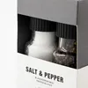 A close-up view of a salt and pepper grinder set in its packaging. Produktbild-Vorschau