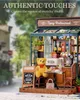 A miniature model of a bistro with a teddy bear sitting at a table. Produktbild-Vorschau