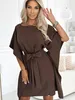 A woman wearing a brown dress. Produktbild-Vorschau