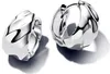 A pair of silver hoop earrings with a rippled texture, presented on a white background. Voir les images du produit