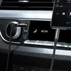A close-up shot of a car's interior, showing an audio cable plugged into the car's auxiliary port and a smartphone. Produktbild-Vorschau